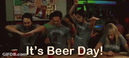 A Group Of People Are Dancing In A Bar And The Words It 'S Beer Day Are Above Them GIF