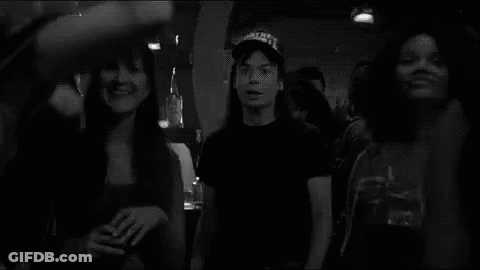 A Group Of People Are Dancing In A Black And White Photo With Schwing Written In White GIF