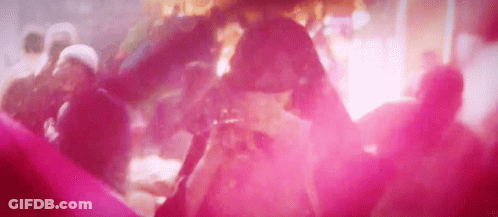 A Group Of People Are Dancing In A Club With Pink Smoke Coming Out Of The Ceiling . GIF
