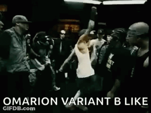 A Group Of People Are Dancing In A Dark Room And A Man Is Standing In The Middle Of The Crowd . GIF