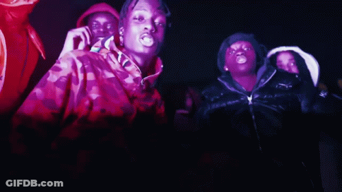 A Group Of People Are Dancing In A Dark Room And One Of Them Is Wearing A Jacket That Says Moncler On It GIF