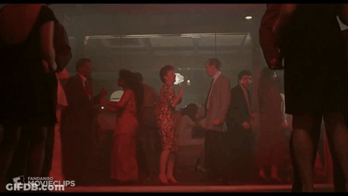 A Group Of People Are Dancing In A Dark Room And The Word Movieclips Is On The Bottom Right GIF