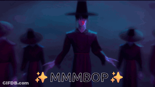 A Group Of People Are Dancing In A Dark Room And The Words Mmmbop Are On The Bottom GIF
