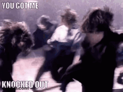 A Group Of People Are Dancing In A Dark Room With The Words `` You Got Me Knocked Out '' . GIF