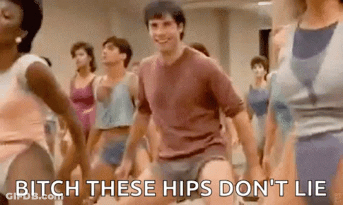A Group Of People Are Dancing In A Gym And A Man Is Holding His Pants Up . GIF