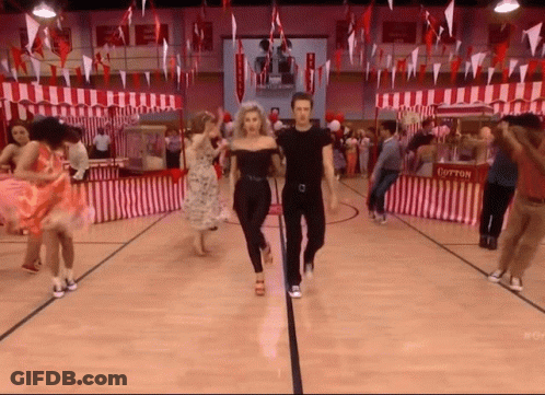 A Group Of People Are Dancing In A Gym With Cotton Candy Stands In The Background GIF
