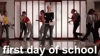 A Group Of People Are Dancing In A Hallway With The Words `` First Day Of School '' Above Them . GIF