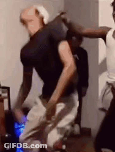 A Group Of People Are Dancing In A Living Room . GIF