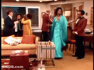 A Group Of People Are Dancing In A Living Room . GIF