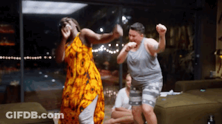 A Group Of People Are Dancing In A Living Room GIF