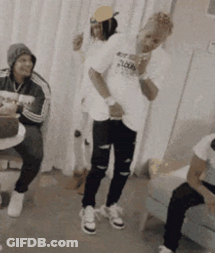 A Group Of People Are Dancing In A Room And One Of Them Is Wearing A Shirt That Says ' Loud ' On It GIF