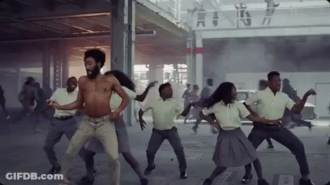 A Group Of People Are Dancing In A Room In A Building . GIF