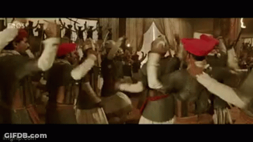 A Group Of People Are Dancing In A Room In A Movie . GIF