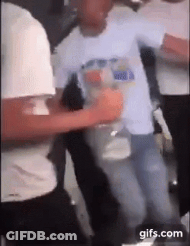 A Group Of People Are Dancing In A Room While A Man Is Holding A Bottle Of Water . GIF