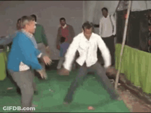 A Group Of People Are Dancing In A Room With A Green Curtain Behind Them GIF