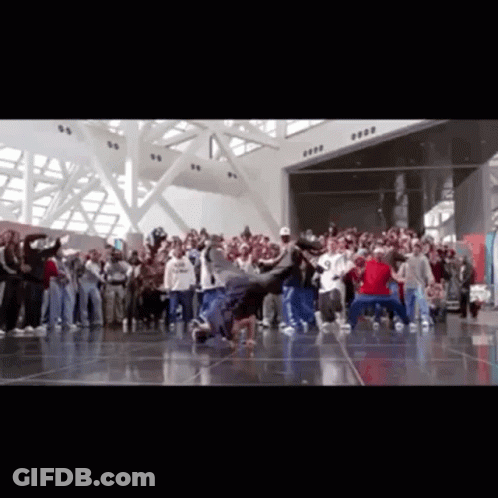 A Group Of People Are Dancing In A Room With A Sign That Says ' 8888 ' On It GIF