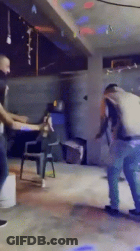 A Group Of People Are Dancing In A Room With A Sign That Says " A " On It GIF