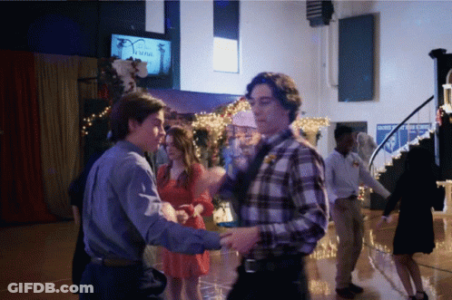 A Group Of People Are Dancing In A Room With A Sign That Says Safety GIF