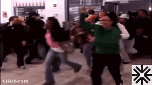 A Group Of People Are Dancing In A Room With A Snowflake In The Corner GIF