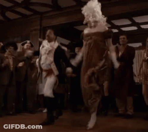 A Group Of People Are Dancing In A Room With A Woman In A Dress . GIF
