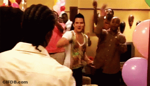 A Group Of People Are Dancing In A Room With Pink Balloons GIF