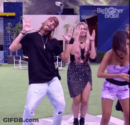 A Group Of People Are Dancing In Front Of A Big Brother Brasil Building GIF