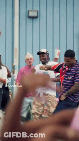 A Group Of People Are Dancing In Front Of A Blue Wall With The Words Realacidgreene On The Bottom GIF