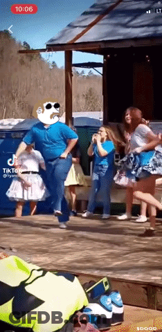 A Group Of People Are Dancing In Front Of A Building With Tik Tok Written On The Screen GIF