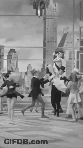 A Group Of People Are Dancing In Front Of A Building GIF