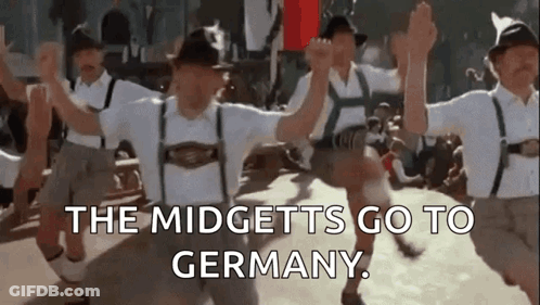 A Group Of People Are Dancing In Front Of A Crowd And The Words `` The Midgets Go To Germany '' Are Written On The Botto GIF