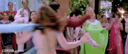 A Group Of People Are Dancing In Front Of A Crowd At A Wedding Reception . GIF