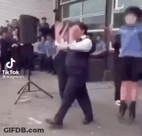 A Group Of People Are Dancing In Front Of A Crowd . GIF