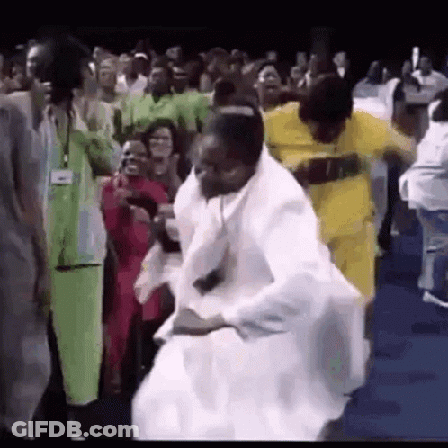A Group Of People Are Dancing In Front Of A Crowd Of People . GIF