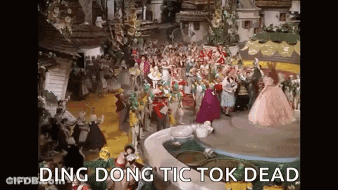 A Group Of People Are Dancing In Front Of A Fountain In A Wizard Of Oz Scene . GIF