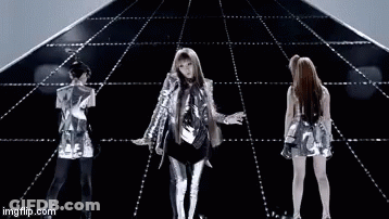A Group Of People Are Dancing In Front Of A Pyramid On A Stage . GIF