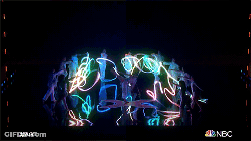 A Group Of People Are Dancing In Front Of A Screen That Says Nbc On It GIF