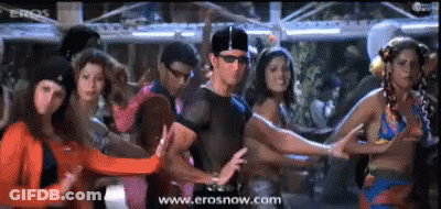 A Group Of People Are Dancing In Front Of A Screen Which Says Erosnow.com GIF