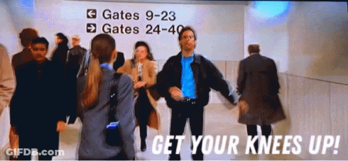 A Group Of People Are Dancing In Front Of A Sign That Says Gates 9-23 GIF