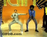 A Group Of People Are Dancing In Front Of A Sign That Says ' Iu ' On It GIF