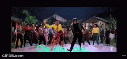 A Group Of People Are Dancing In Front Of A Sign That Says Ole Ole Ole .. GIF