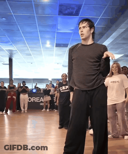 A Group Of People Are Dancing In Front Of A Sign That Says Orea On It GIF