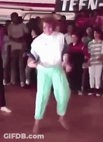A Group Of People Are Dancing In Front Of A Sign That Says Teen GIF
