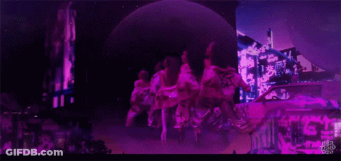 A Group Of People Are Dancing In Front Of A Sign That Says ' Tokyo Pop ' GIF