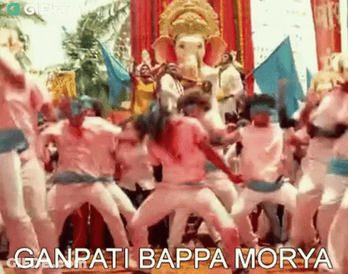 A Group Of People Are Dancing In Front Of A Statue Of Ganesha . GIF
