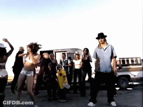 A Group Of People Are Dancing In Front Of A Truck That Says ' R.i.p. ' On The Back GIF