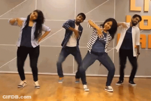 A Group Of People Are Dancing In Front Of A Wall That Has The Letter U On It GIF