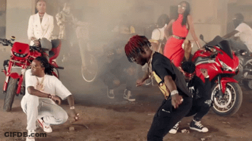 A Group Of People Are Dancing In Front Of Motorcycles And Smoke Coming Out Of Them GIF