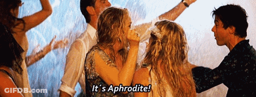 A Group Of People Are Dancing In The Rain And One Of Them Is Saying It 'S Aphrodite GIF