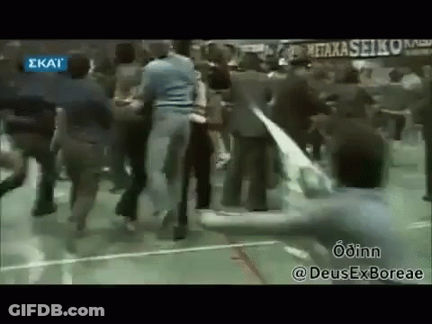 A Group Of People Are Dancing On A Basketball Court In A Gym . GIF