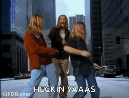 A Group Of People Are Dancing On A City Street With The Words Heckin Yaaas Written On The Bottom . GIF